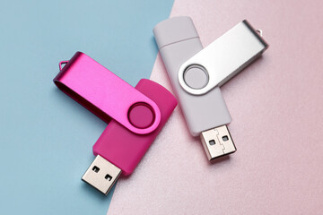 Two USB flash drives on color background
