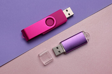 Colorful USB flash drives on color background