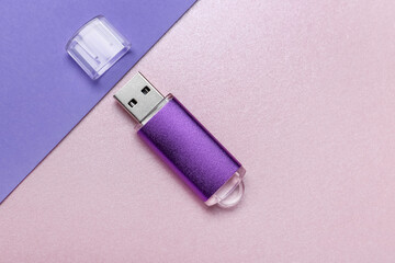 USB flash drive with cap on color background