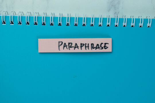 Concept of Paraphrase write on sticky notes isolated on Wooden Table.