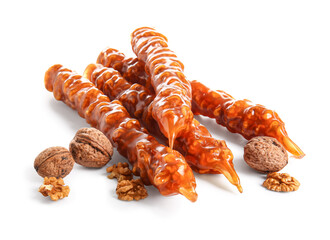 Tasty churchkhela and walnuts on white background