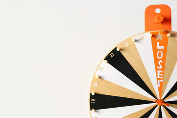 Spinning wheel with word LOSER on white background, closeup