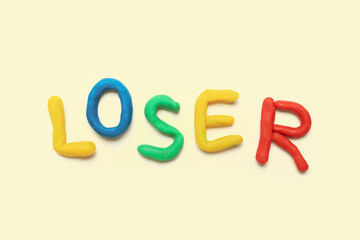 Word LOSER made of plasticine on white background