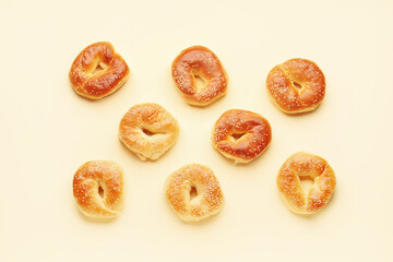 Tasty bagels with sesame seeds on beige background