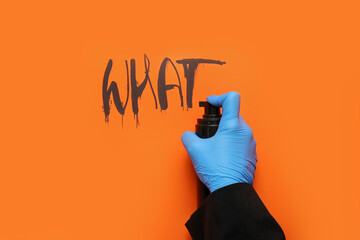 Woman in rubber glove spraying word WHAT on red background