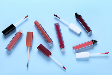 Set of different liquid lipsticks on color background