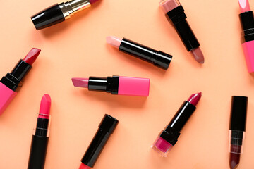 Set of different lipsticks on color background