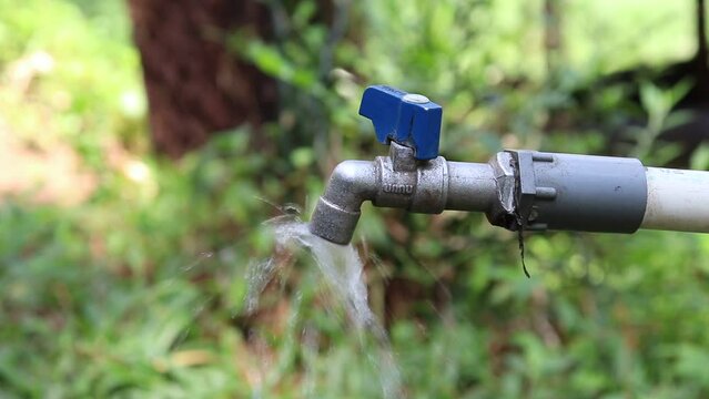 video of an outdoor water faucet that is being opened
