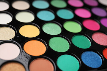 Beautiful eyeshadow palette as background, closeup. Professional cosmetic product