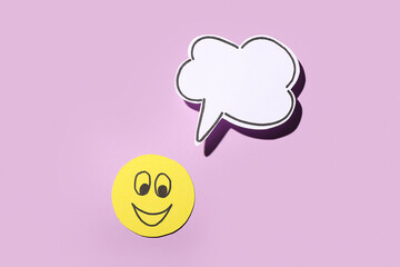 Paper smile with speech bubble on lilac background. Dialogue concept