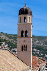 Fototapeta na wymiar View to the Bell Tower of Franciscan Church. Old Town of Dubrovnik, Croatia