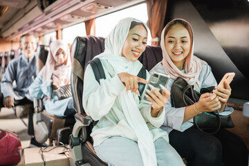 happy muslim woman using phone while travel by bus during eid mubarak holiday
