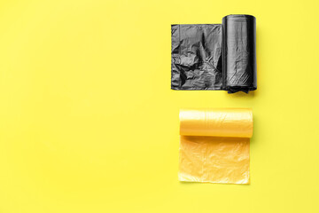 Different rolls of garbage bags on yellow background