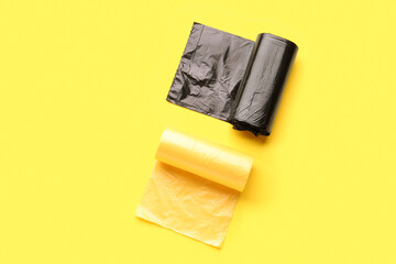 Different rolls of garbage bags on yellow background