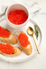 Tasty bruschettas with red caviar on grunge background