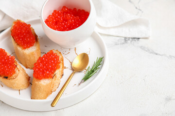 Tasty bruschettas with red caviar on grunge background