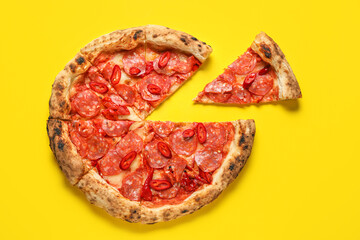 Delicious pepperoni pizza on yellow background