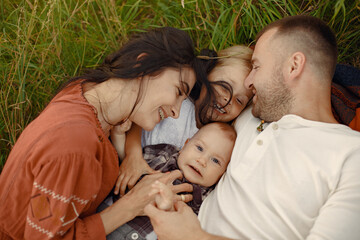 Cute family playing in a summer field