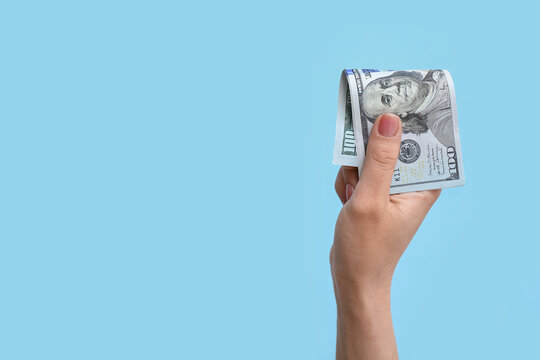 Woman with dollar banknote on blue background