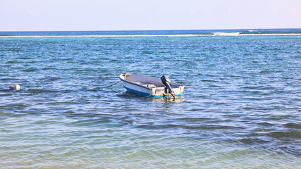 The natural beauty of the Eastern District, East End of the Cayman Islands, Grand Cayman, with fishing boat floating in the pristine beach with crystal-clear waters, a perfect tropical paradise 