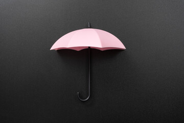 Pink umbrella isolated on black background