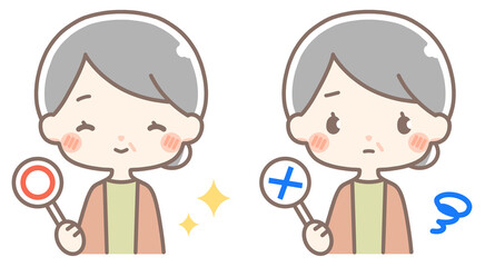 丸とバツの札を持つシニア女性