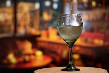 Close up of glass while the wine is falling in the glass with wine in action 