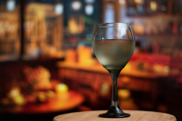 Close up of glass of wine filled of rose wine in vintage bar and copy space