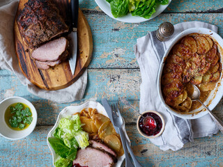 Flatlay image of a dinner with meat, potatoe gratin and salad