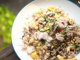 Thai fried rice with egg, mackerel and climbing wattle or Cha-om leaves