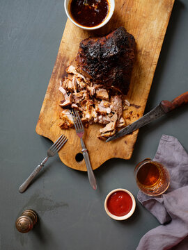 Pulled pork dinner served with sauces, roasted potatoes and salad