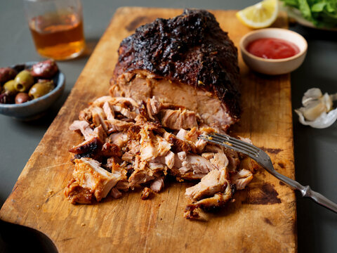 Pulled pork dinner served with sauces, roasted potatoes and salad