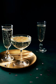 Prosecco Glasses and Gold Plate on Green Background