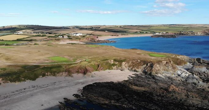 Aerial pan of Thurlestone, an English village. Captivating view from ocean to land.