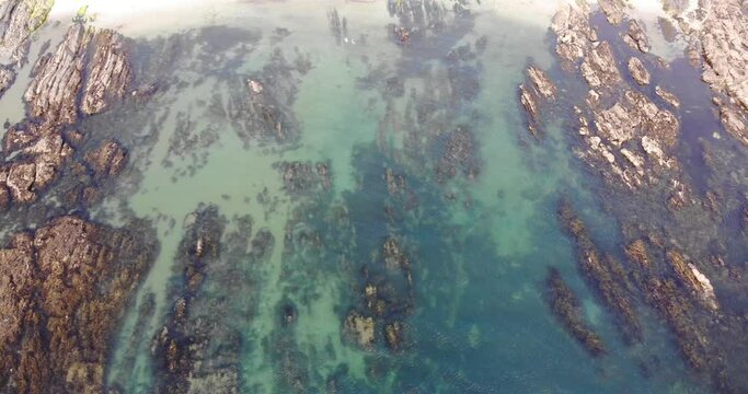 Thurlestone, England Village. Bird&rsquo;s eye view of clear blue water and rocks off coast.