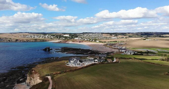 Thurlestone, England Village. Clouds in blue sky over beautiful coastline.