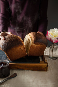 Homemade Fresh Milkbread Loaf with a woman breaking it apart