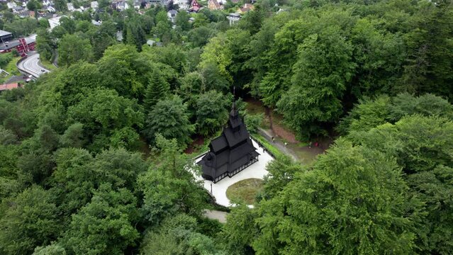 Medieval viking church,in sunny Fantoft, Norway - high angle, orbit, drone shot