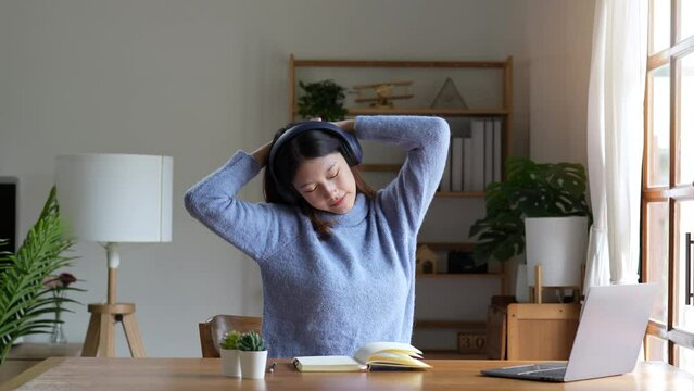Happy woman stretch oneself for relaxing activity feeling lazy on weekend on desk