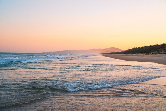 Beautiful panorama of the Peregian Beach nestled against the dunes of a pristine white sand beach with surfing breaking waves on the Sunshine Coast, Queensland, Australia. 