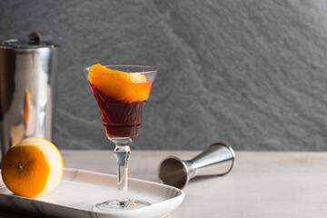 Boulevardier cocktail boozy bourbon whiskey, bitter and sweet vermouth with orange peel as garnish