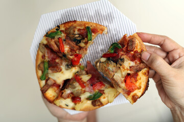 Taking pizza slices from cardboard boxes. Margherita and quattro formaggi pizza. Pizza in a delivery box