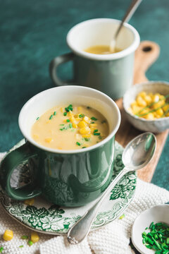 Corn Chowder served in a green mug with sweetcorn