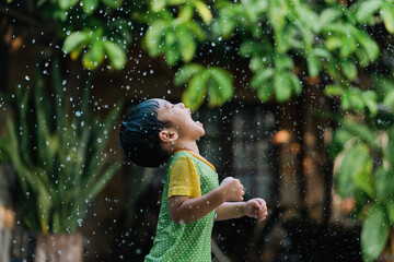 Asian children playing in the rain