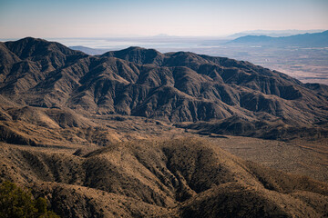2023-01-27 ROLLING HILLS WITH A BROWN COLOR AND TEXTURE IN JOSHUA TREE NATIONAL PARK IN CALIFORNIA WITH THE SALTON SEA AND PALM SPRINGS INTHE BACKGROUND