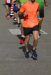 runners during the marathon on the city streets run in sneakers