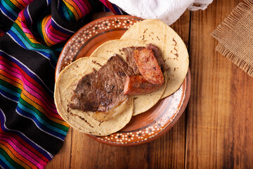 Roast meat (carne asada) very popular dish in northern Mexico, also called Asado, Discada or Parrillada, is a cooking technique in which food is exposed to the heat of the embers.