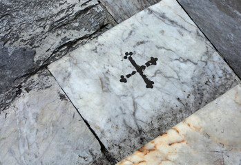 Step with black cross in the place where Saint Catherine fell pushed by the devil in Siena in Italy - obrazy, fototapety, plakaty