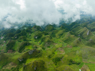 Top view of green mountains and hills covered with clouds. Osmena Peak. Mountain landscape. Cebu Philippines.