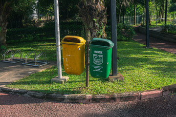 Multi colors recycle bin garbage in public park to save environment care and reduce trash. Make Earth more clean and reduce junk. Helping the environment